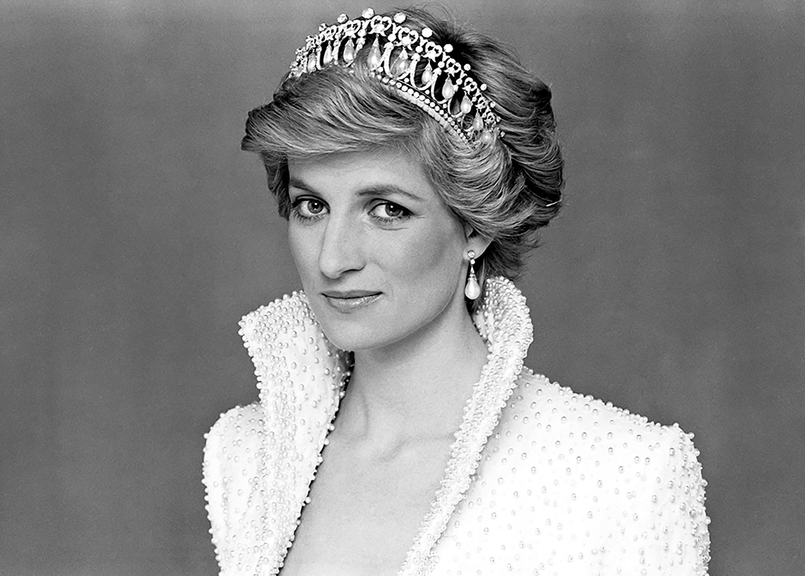 Black-and-white portrait of Princess Diana wearing a tiara, symbolizing her enduring legacy, influence, and continued economic impact on fashion, media, and tourism.