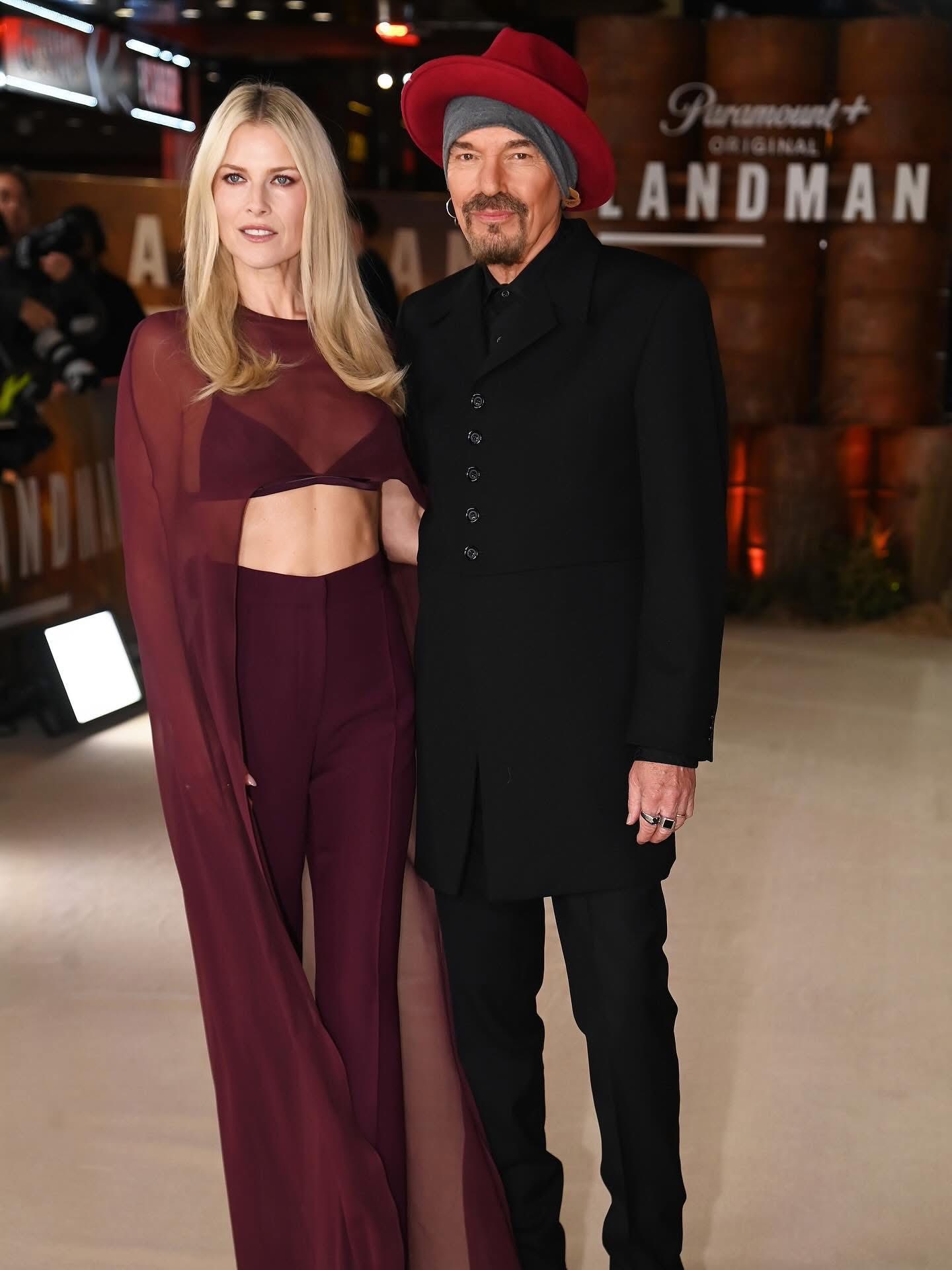 Ali Larter and Billy Bob Thornton pose together on the red carpet at the Landman Season 2 London premiere, with Larter in a sheer burgundy bralette and cape and Thornton in a classic suit.