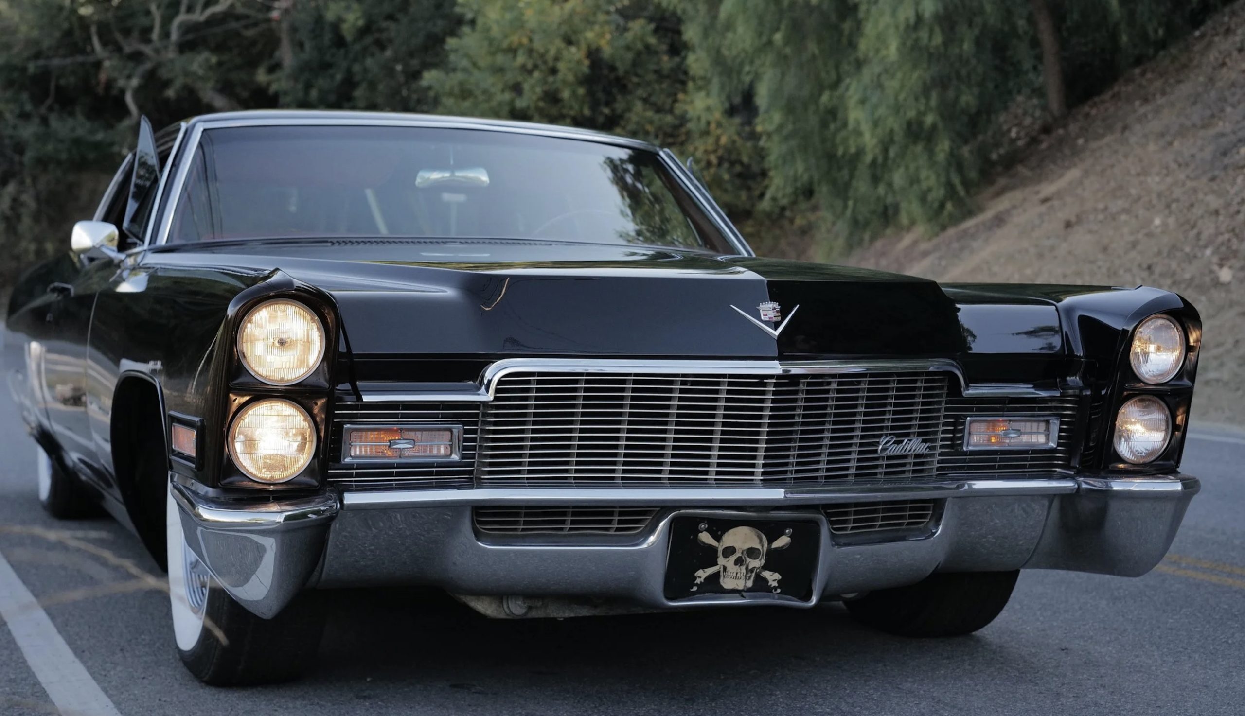 Justin Bieber’s 1968 Cadillac Coupe DeVille from the “Peaches” music video driving down a scenic mountain road.