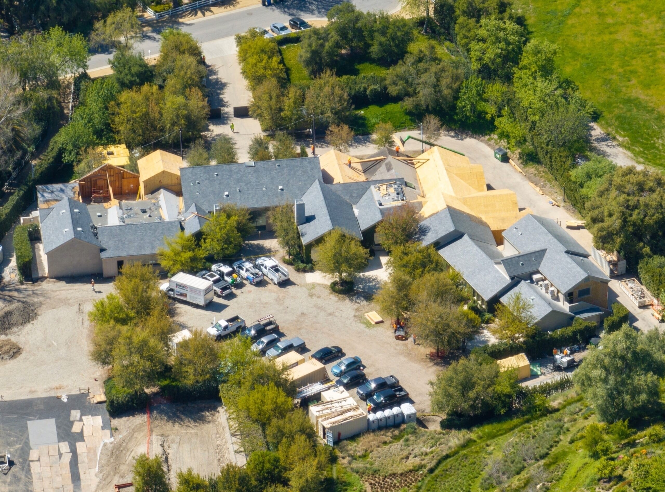 Aerial view of Kim Kardashian’s Hidden Hills mansion under renovation, showing construction progress and exposed wooden framework.