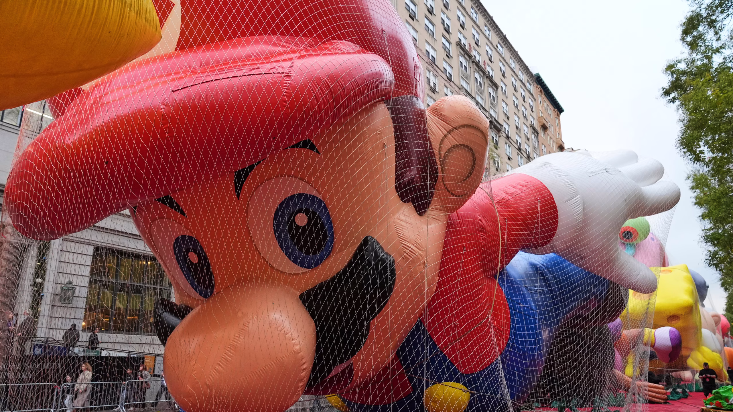 A giant Mario balloon floats high above the streets of Manhattan during a recent Macy’s Thanksgiving Day Parade, with handlers guiding it safely along the route.