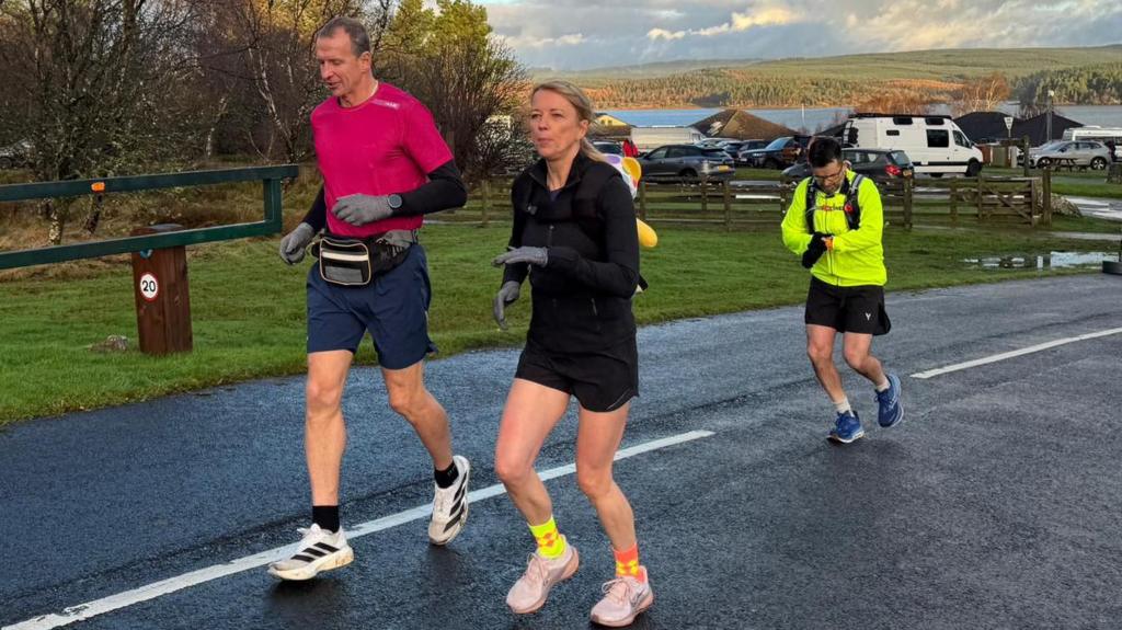 Sara Cox sets off on Day 1 of her Great Northern Marathon Challenge, running through Kielder Forest while carrying Pudsey Bear for Children in Need.