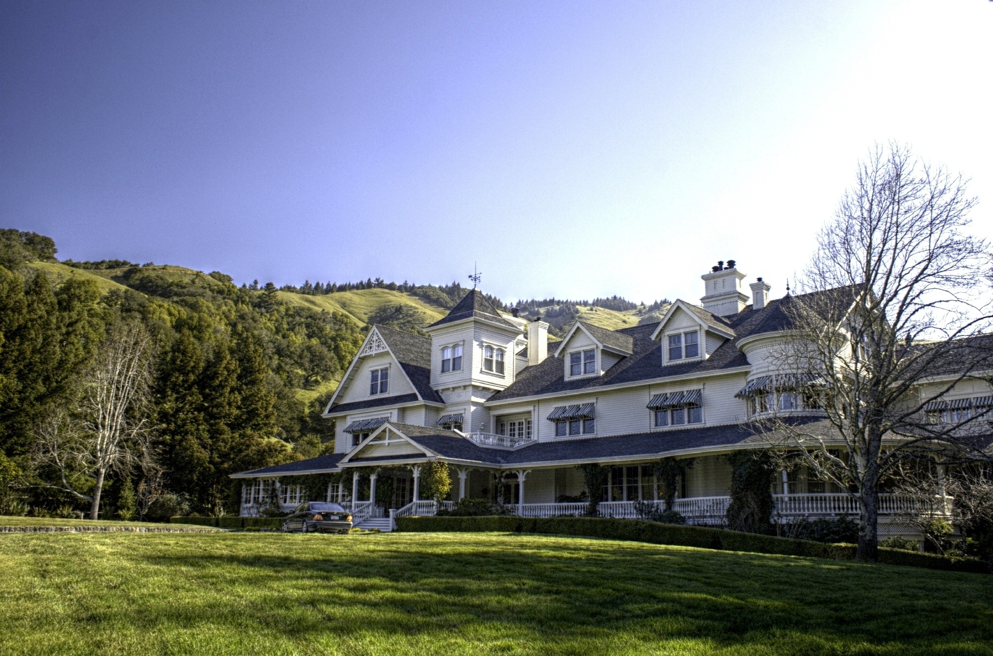 Aerial view of the Skywalker Ranch main house, surrounded by lush greenery, rolling hills, and sprawling estate grounds in Marin County, California.