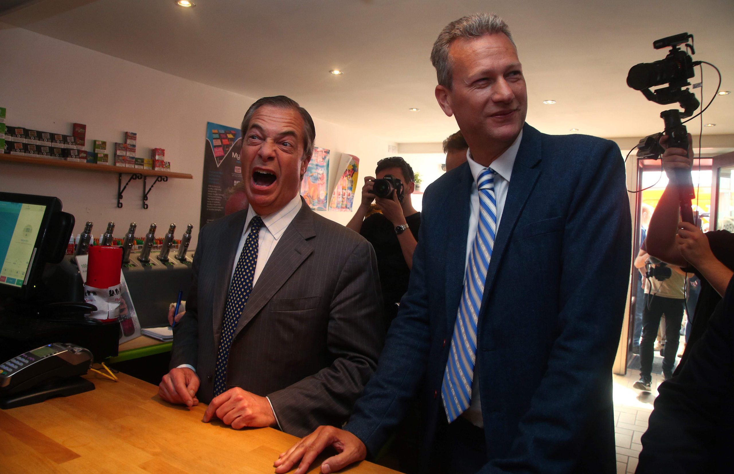Nathan Gill and Nigel Farage laughing together in a pub, sharing drinks in a relaxed setting that contrasts sharply with the later revelations of Gill’s secret pro-Russian payments.