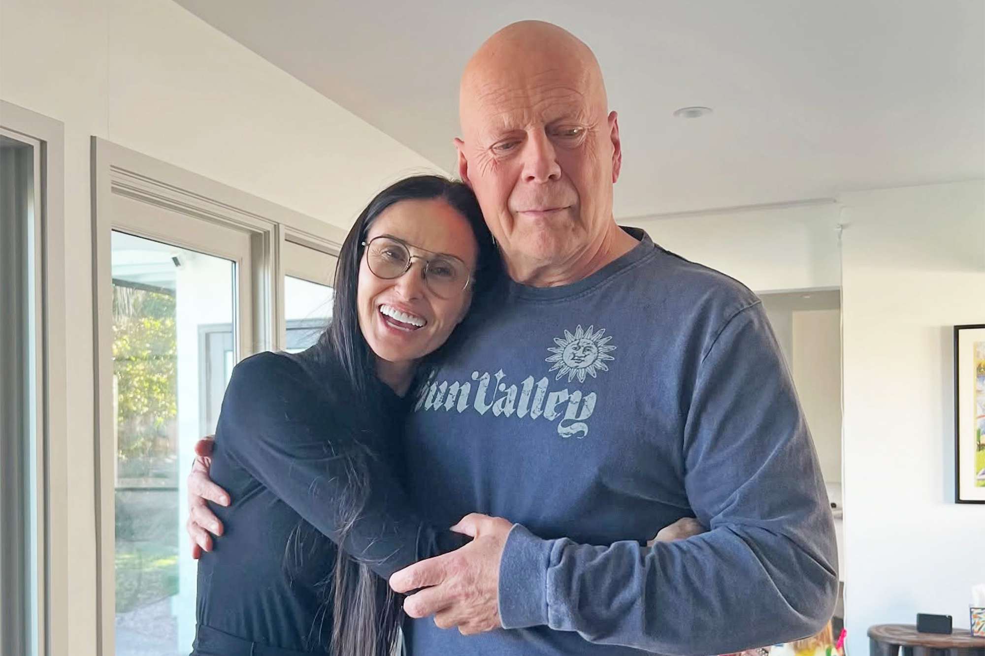 Demi Moore hugging Bruce Willis, who looks visibly ill, as he battles Dementia