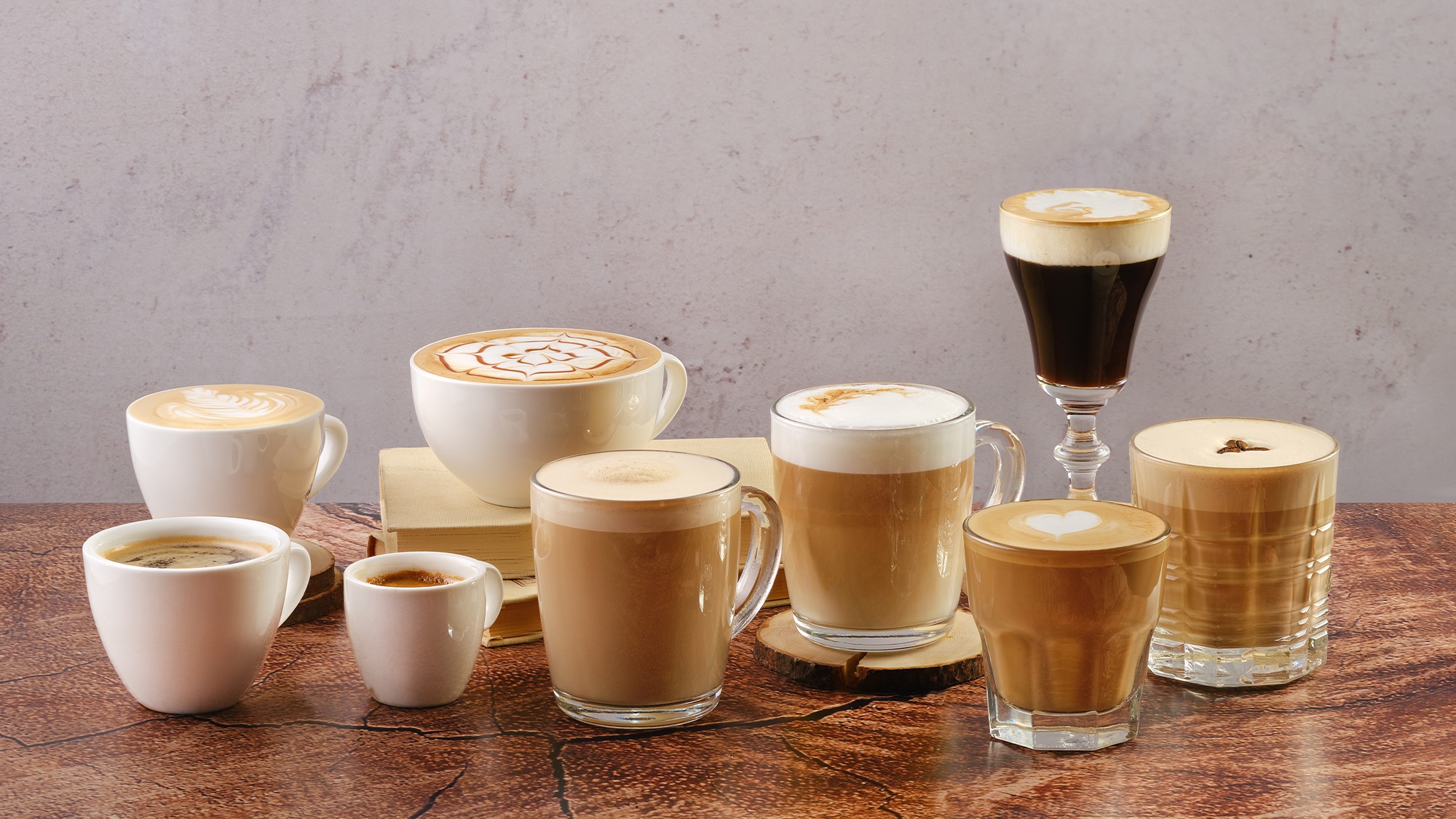 A large selection of pre-packaged lattes arranged on a table, highlighting popular milk-based drinks that will be affected by the UK sugar tax from 2028.