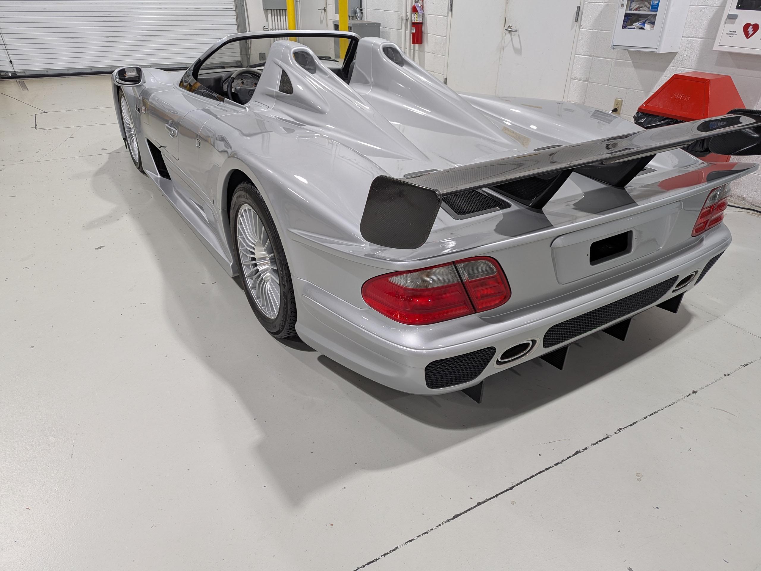 Rear view of the ultra-rare 2002 Mercedes-Benz CLK-GTR Roadster, highlighting its wide stance, sculpted tail, and signature dual exhausts.