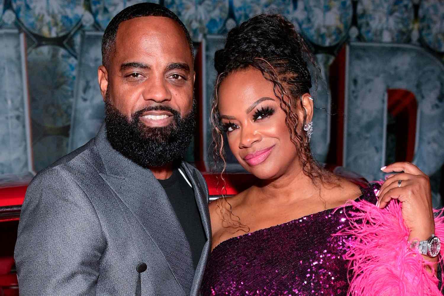 Kandi Burruss and Todd Tucker, fully glammed up, smiling together in a posed photo from happier times.