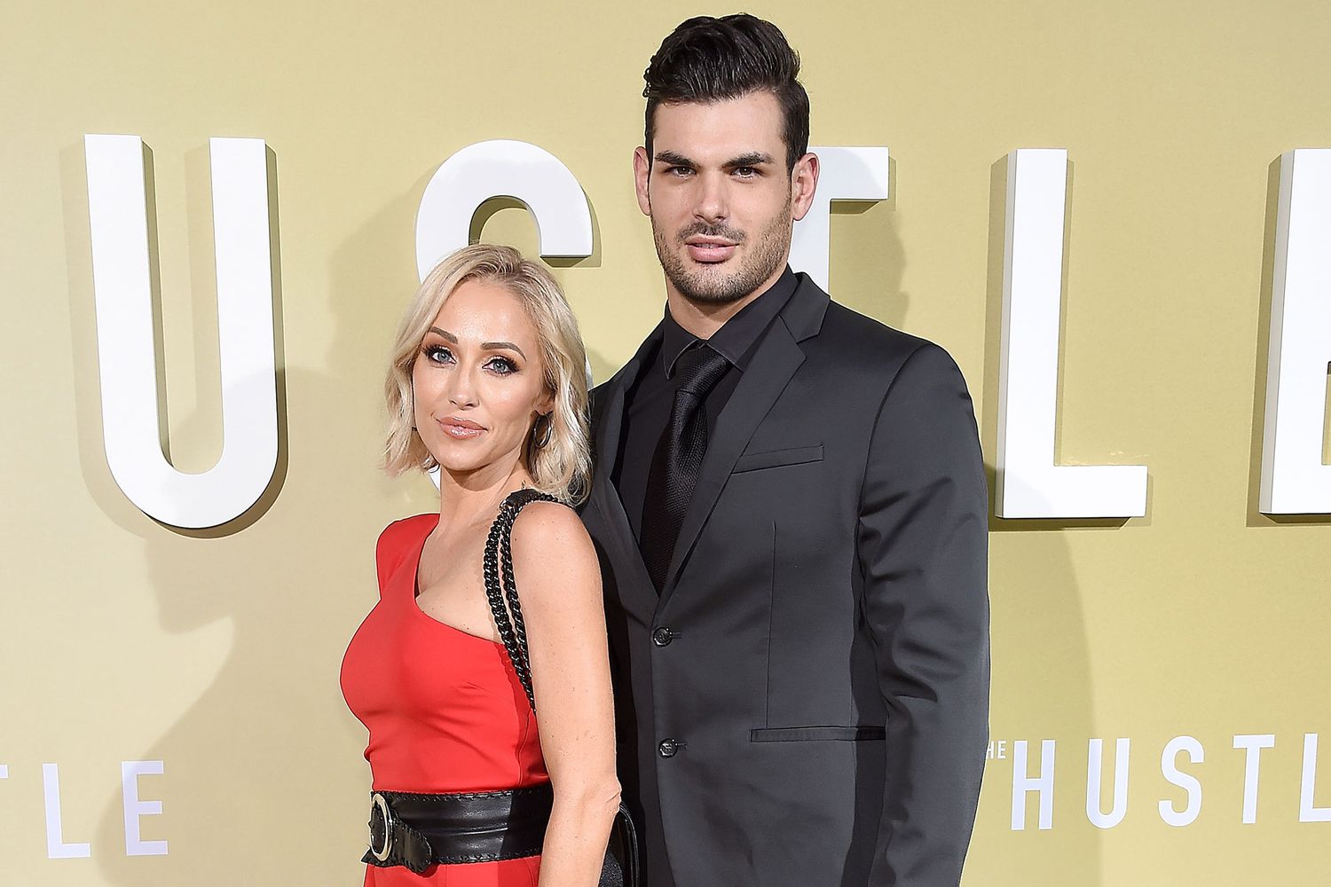 Mary Bonnet and Romain Bonnet posing together on the red carpet, standing close and smiling for photographers.