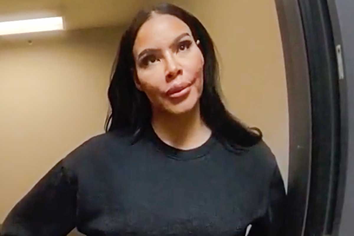 Mia Thornton in custody at a police station, appearing distressed as officers process her arrest connected to the alleged theft of $11,000 in furniture.