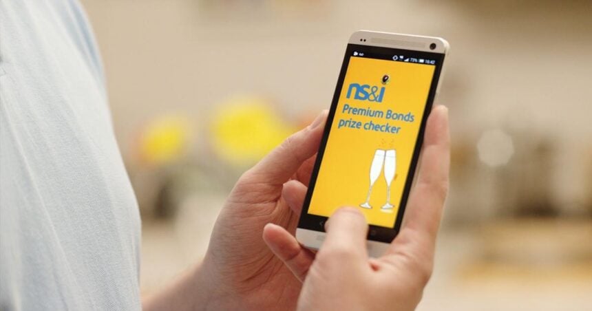 Person checking the NS&I website on their smartphone to see if they have won a Premium Bonds prize.