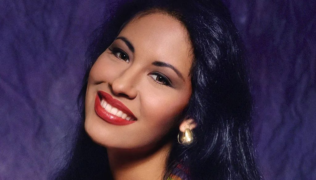 Selena Quintanilla smiling warmly at the camera, radiating her iconic charm and enduring legacy.