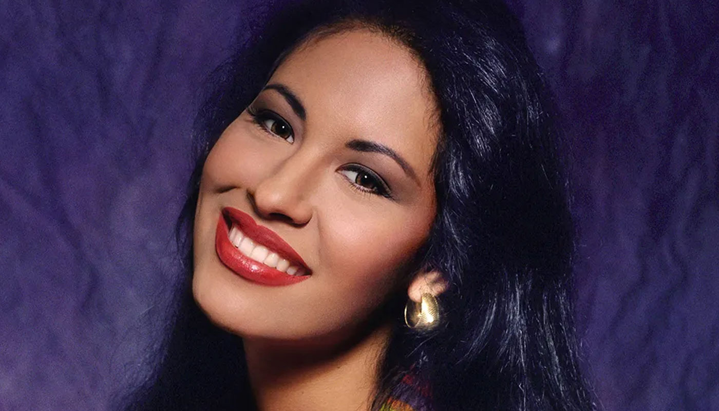 Selena Quintanilla smiling warmly at the camera, radiating her iconic charm and enduring legacy.