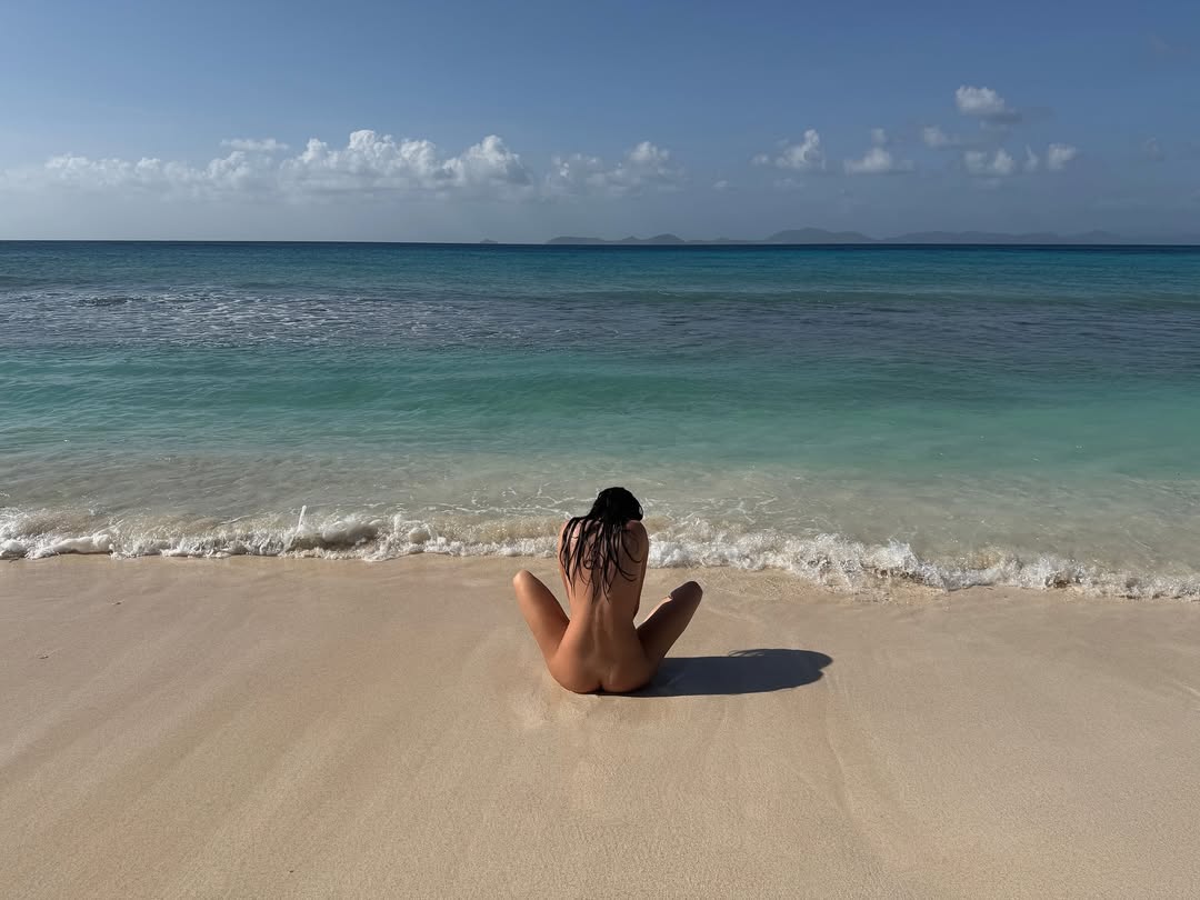 Kendall Jenner sits completely nude on the beach, facing the sea, part of her 30th birthday photo dump that highlights her body-positive image while boosting Instagram engagement and brand reach.