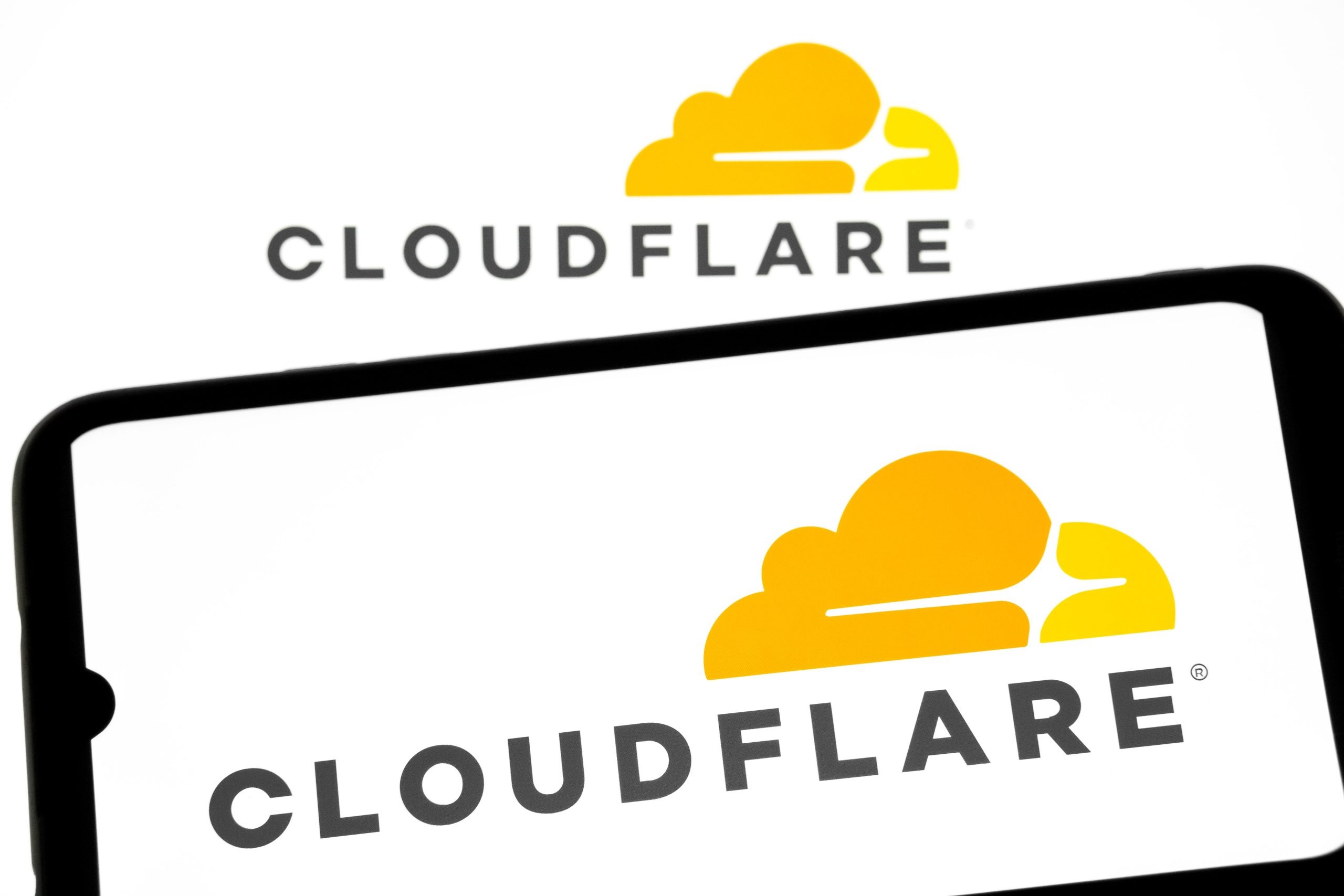 A smartphone screen displaying the Cloudflare logo amid a red error alert overlay, symbolizing the November 18, 2025 outage that disrupted X, ChatGPT, and global web traffic, leading to a $1.8 billion stock plunge.