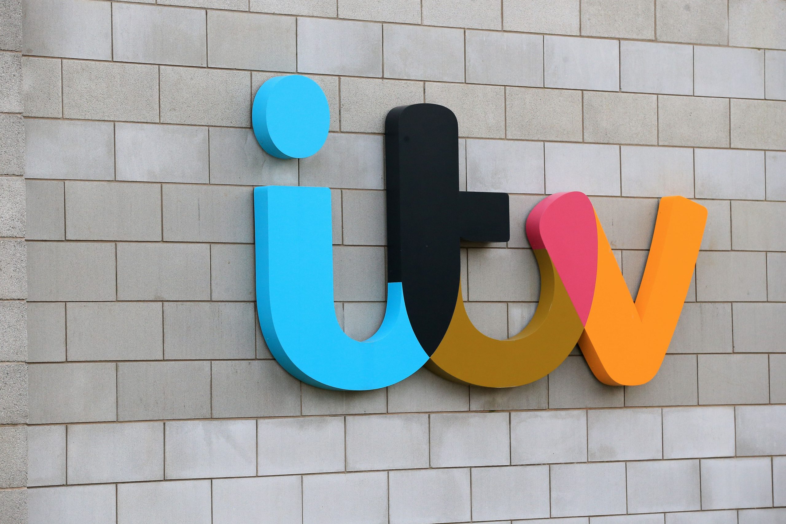 The ITV logo displayed prominently on the exterior wall of the broadcaster’s London studios.