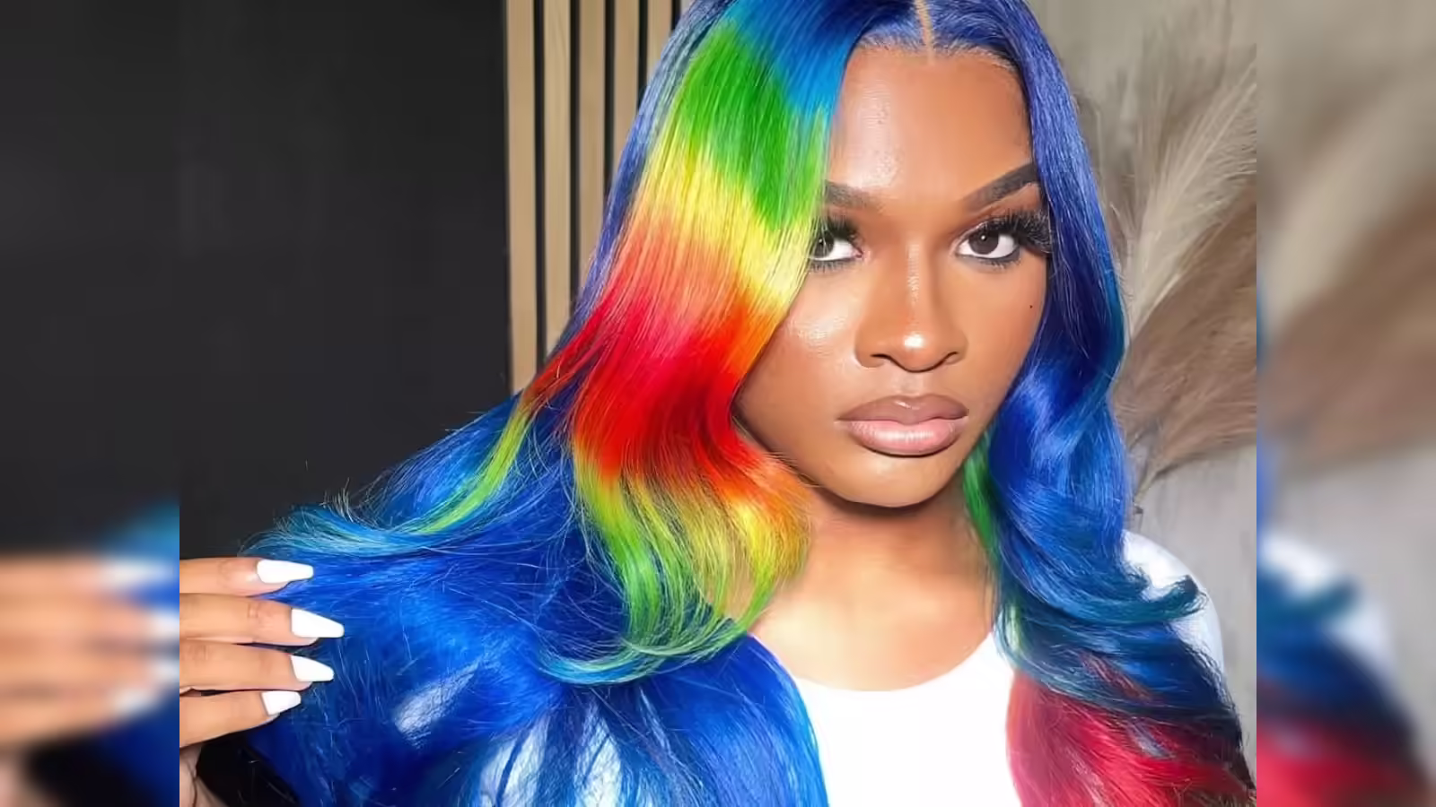 In one of her most iconic TikTok moments, Maurice "Girlalala" Harrison strikes a fierce pose with vibrant rainbow hair, embodying the bold creativity that captivated 200,000 followers and fueled her rise.