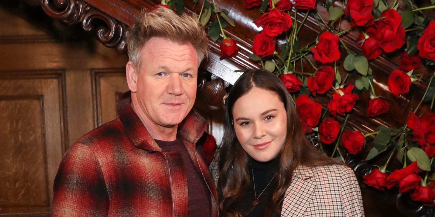 Holly Ramsay standing beside her father Gordon Ramsay, both smiling for the camera at a formal event.
