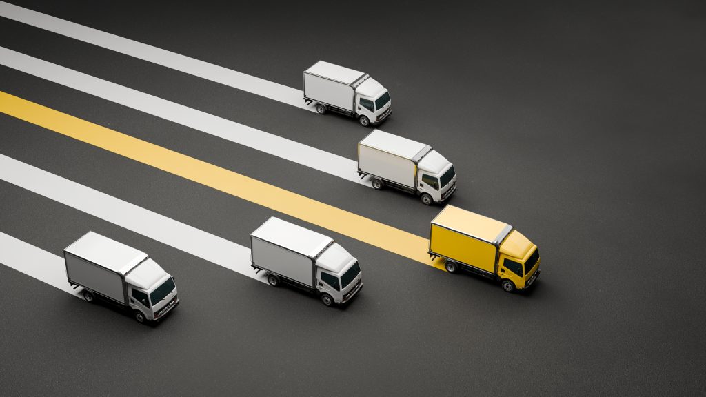 Yellow semi-truck leads a modern fleet, symbolizing strategic fleet management, technology, and operational efficiency for business scaling.