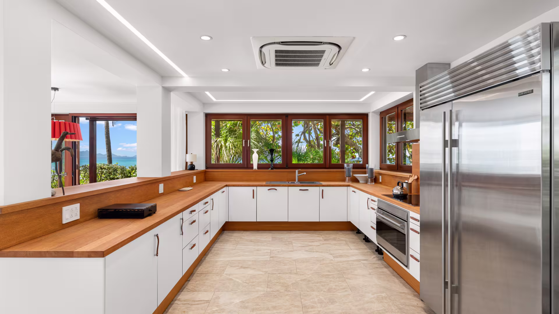 Interior view of the professional-grade kitchen in Chuck Norris’ Anguilla villa, featuring stainless steel appliances, a multi-burner range, and expansive prep counters.