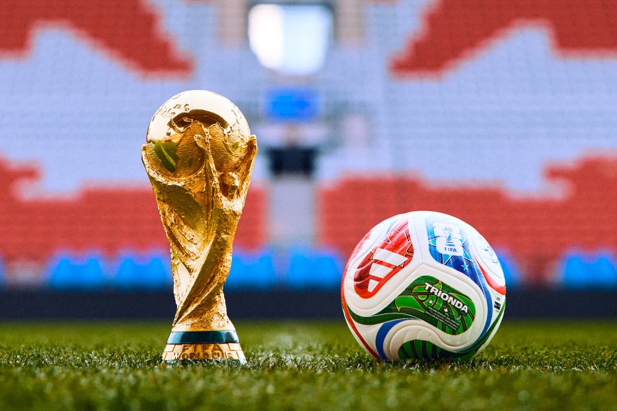 Iconic FIFA World Cup trophy beside official match ball for 2026 tournament.