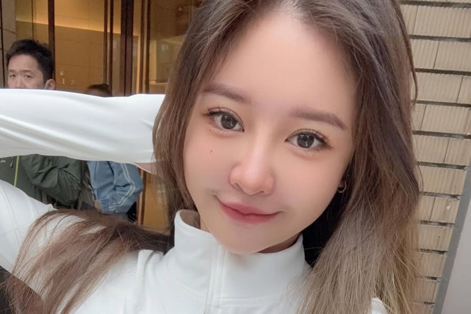 Iris Hsieh smiling while taking a selfie, showing her cheerful and engaging personality.