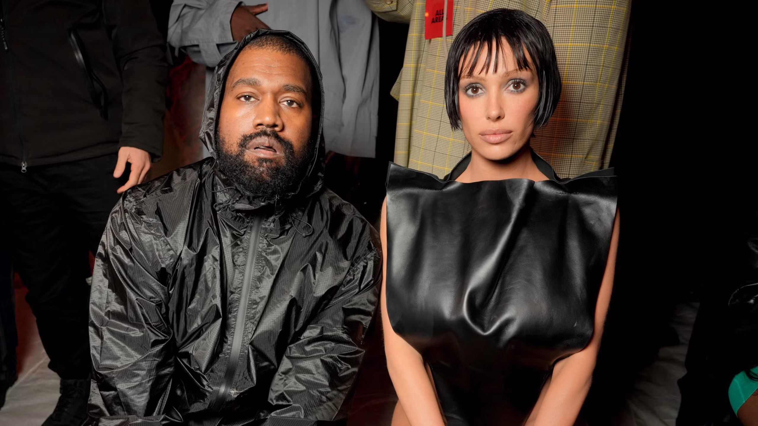 Bianca Censori and Kanye West posing together at an awards event in eccentric, standout outfits.