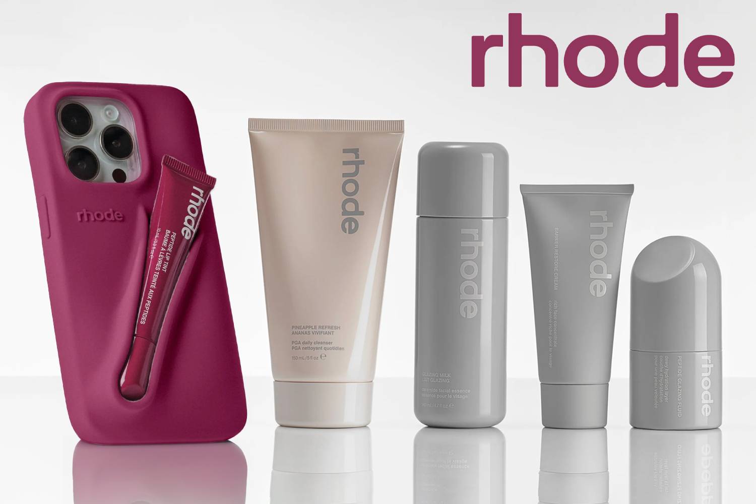 RHODE skincare and makeup products neatly arranged, featuring creams, serums, and cosmetics in minimalist packaging reflecting the brand’s luxury aesthetic.