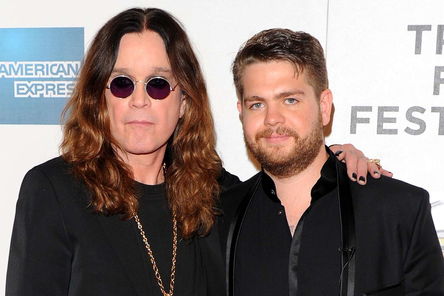 Jack Osbourne and Ozzy Osbourne posing together for cameras at an event.