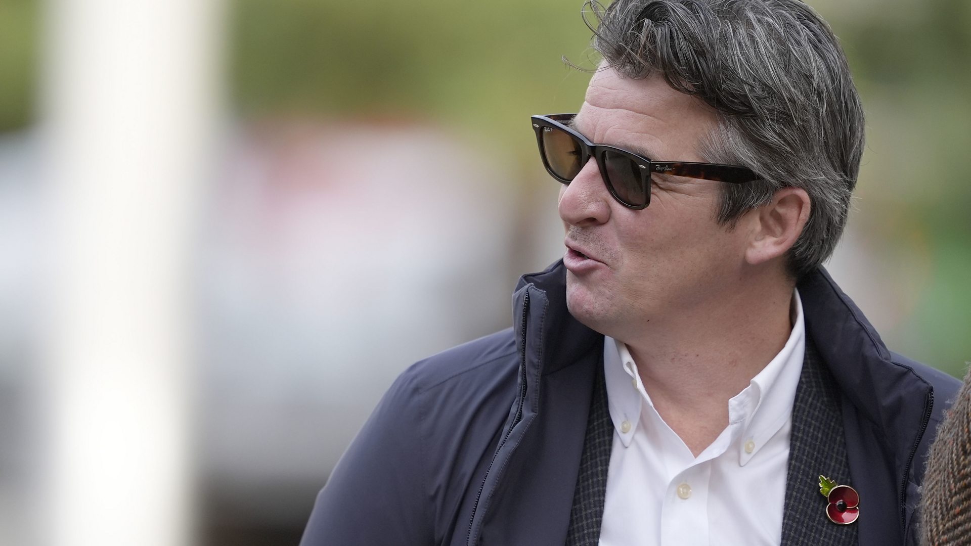 Joey Barton laughs and chats with companions while walking away from Liverpool Crown Court after being convicted of sending grossly offensive social media posts.