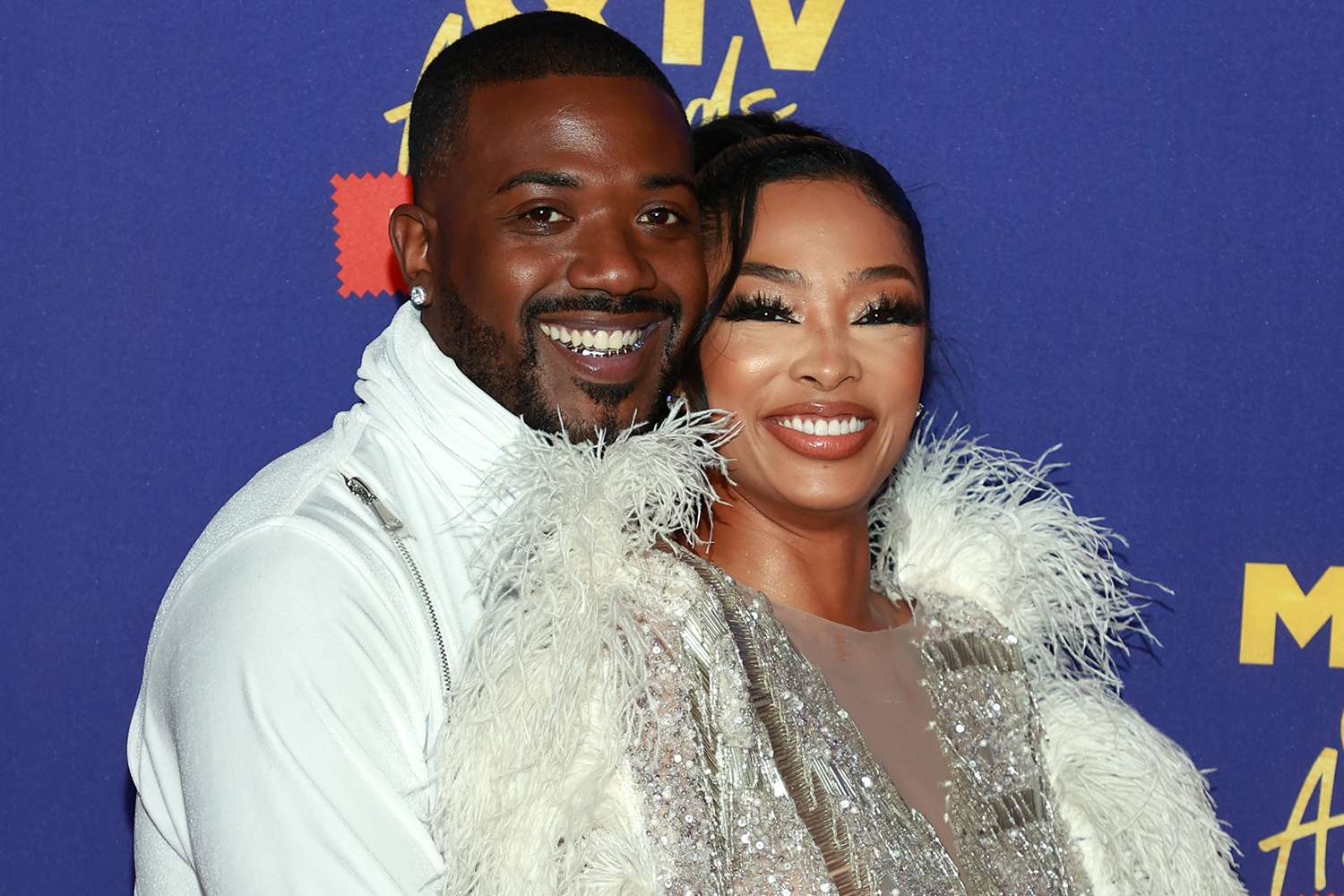 Ray J and Princess Love posing together on the red carpet, smiling for photos before their recent livestream altercation and legal dispute.