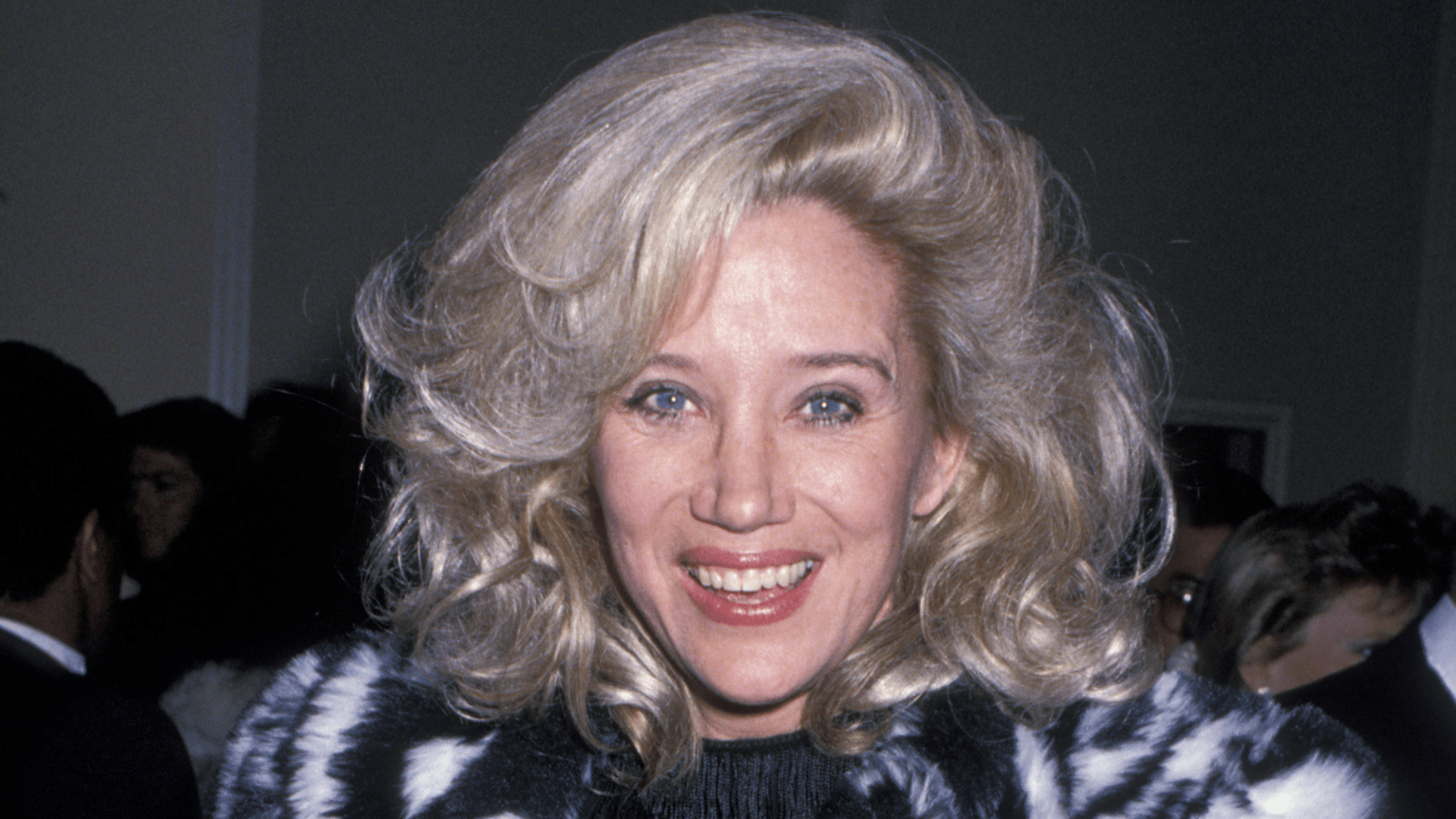 Sally Kirkland smiling confidently on the red carpet during the peak of her Hollywood career.