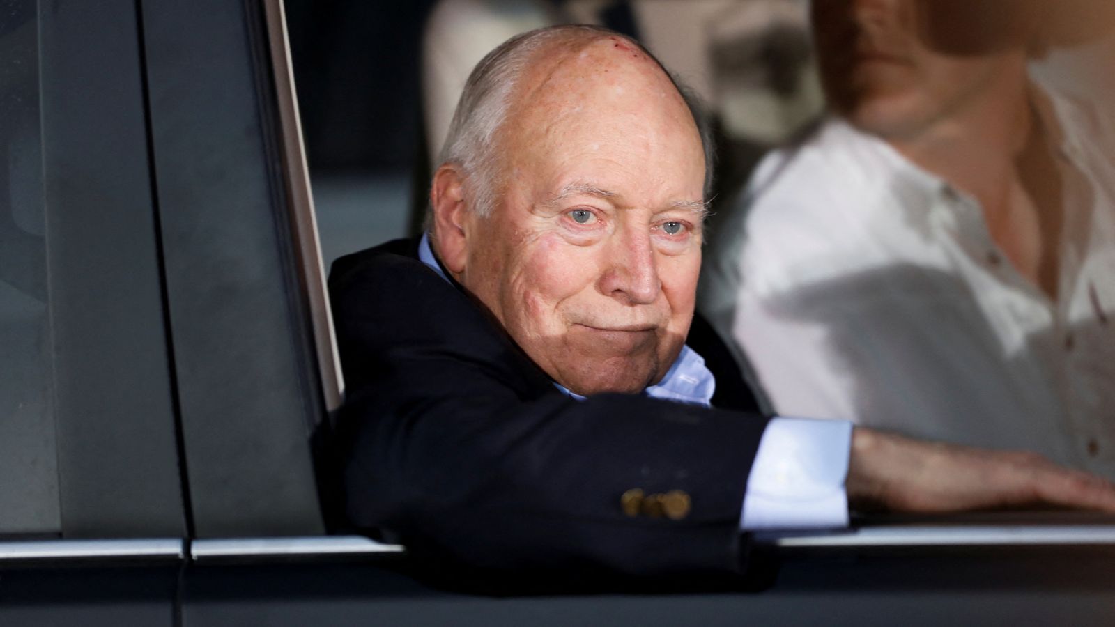 Dick Cheney looking thoughtfully out of a car window, appearing reflective in a recent photo.