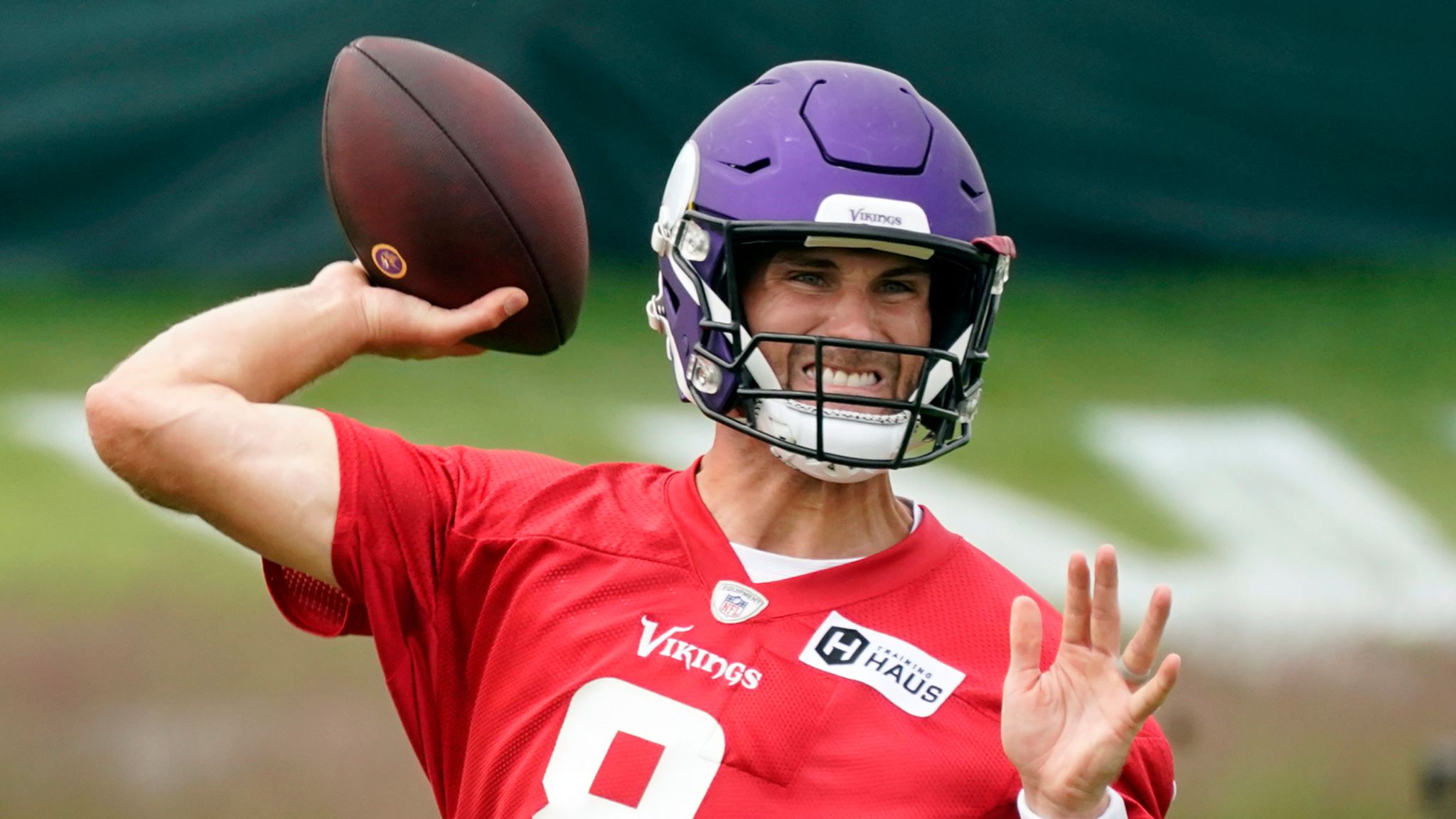 Kirk Cousins throwing a football during a Falcons training session.