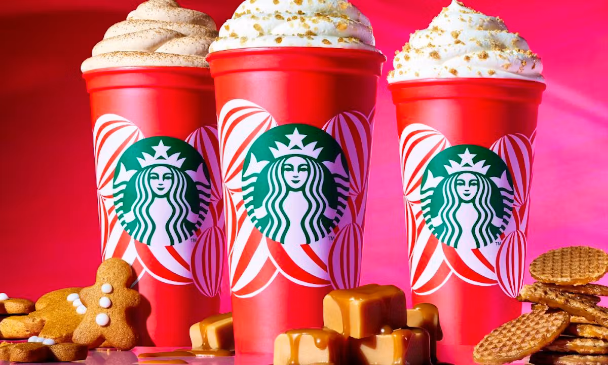 Starbucks 2025 holiday menu poster featuring three festive drinks: Peppermint Mocha, Caramel Brulée Latte, and Iced Sugar Cookie Latte, adorned with holiday decorations.