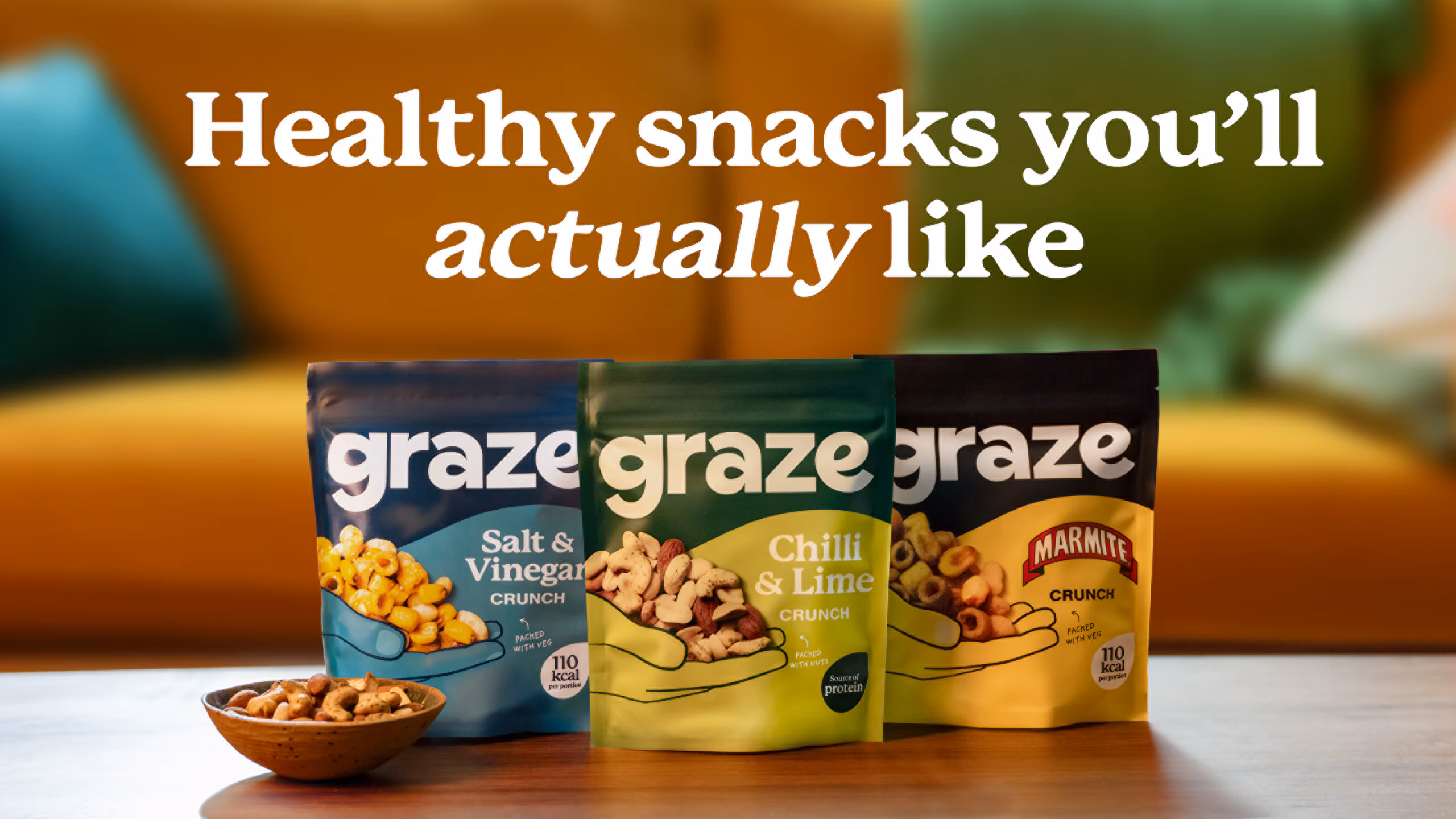 Three packs of Graze snacks arranged side by side, with the slogan displayed prominently above them.