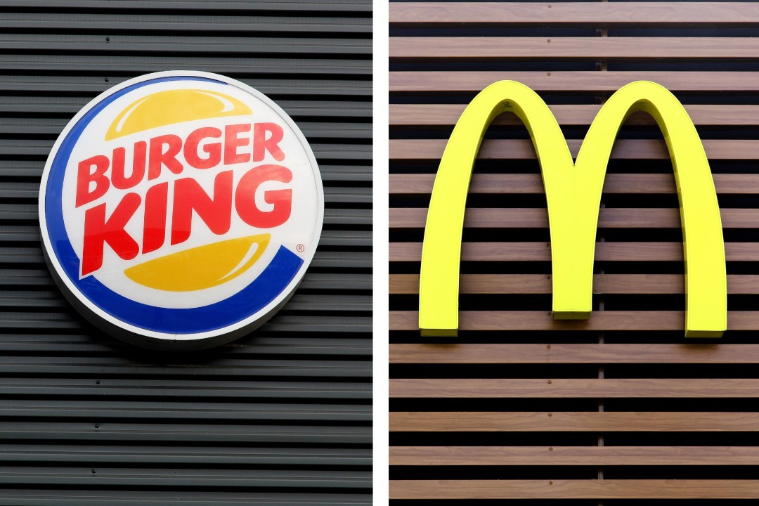 A split image showing the Burger King logo on one side and the McDonald’s golden arches logo on the other, representing the fast-food rivalry highlighted by the one-cent Whopper campaign.
