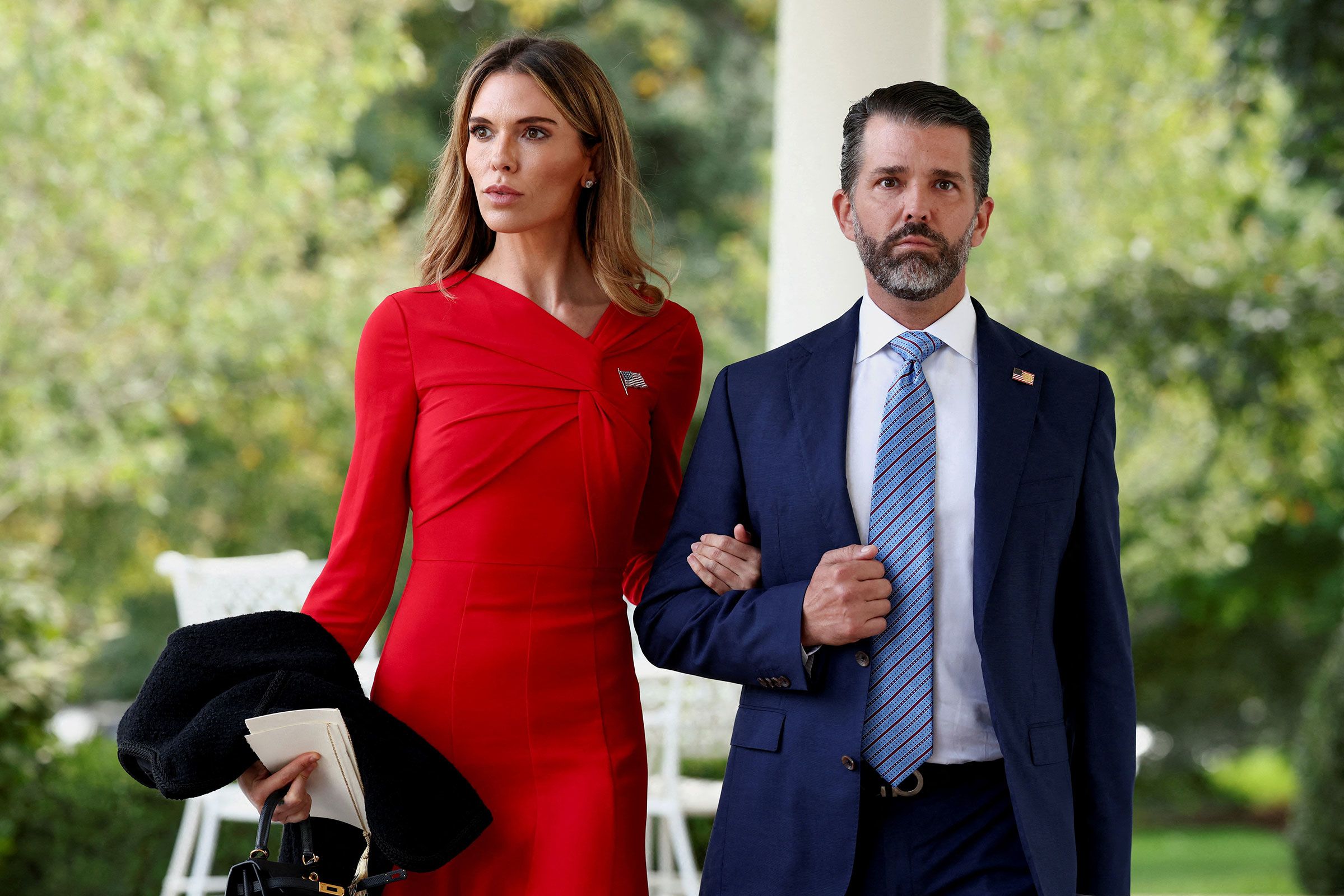 Donald Trump Jr. and Bettina Anderson walk together outside the White House following their engagement announcement.