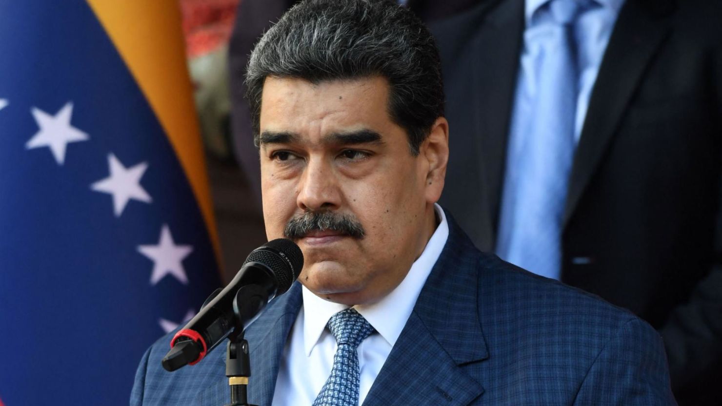 Venezuelan President Nicolás Maduro speaking passionately at a rally, gesturing with his hands as he addresses supporters.