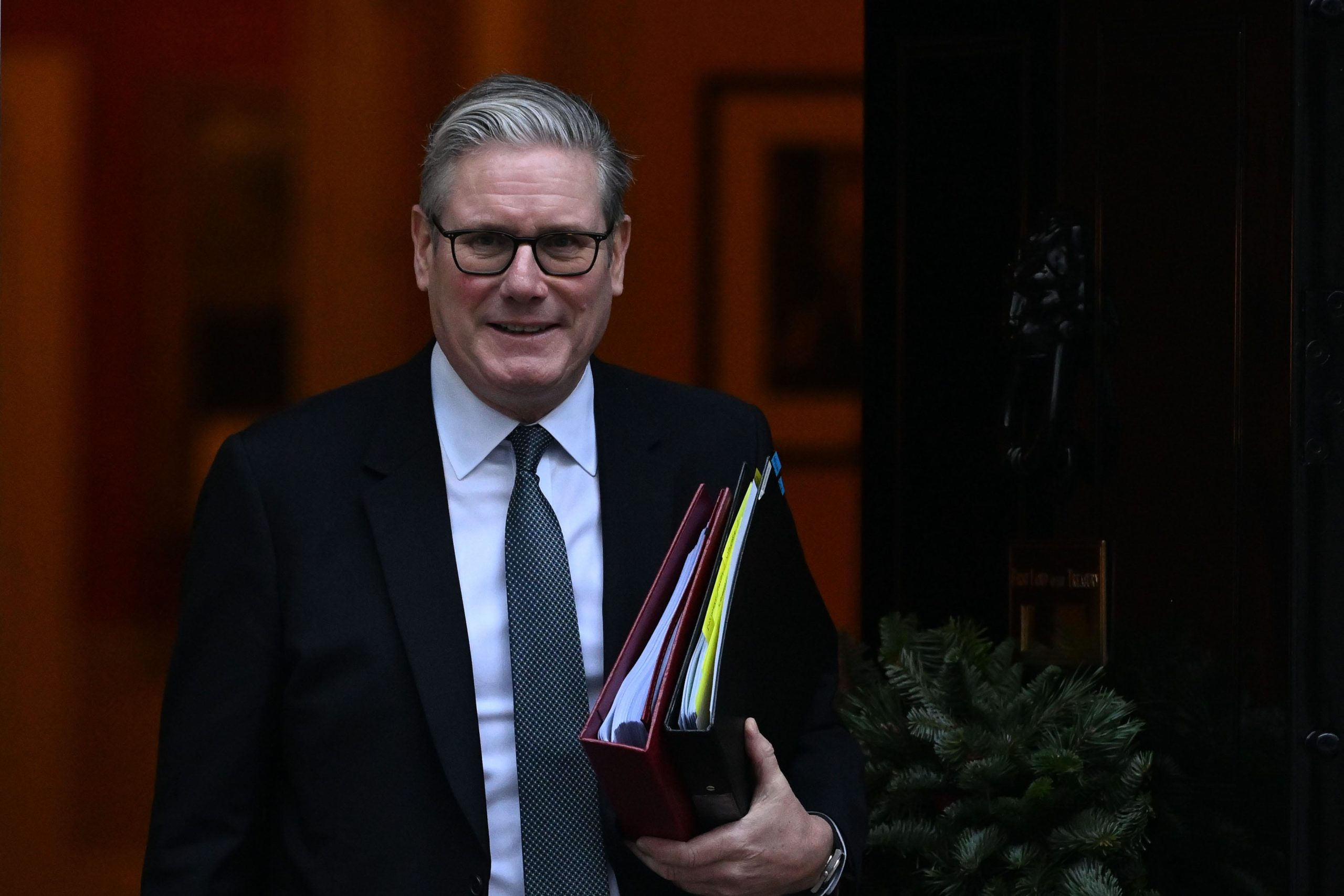 Keir Starmer smiling at a public event, representing his support for expanding facial recognition technology across the UK.
