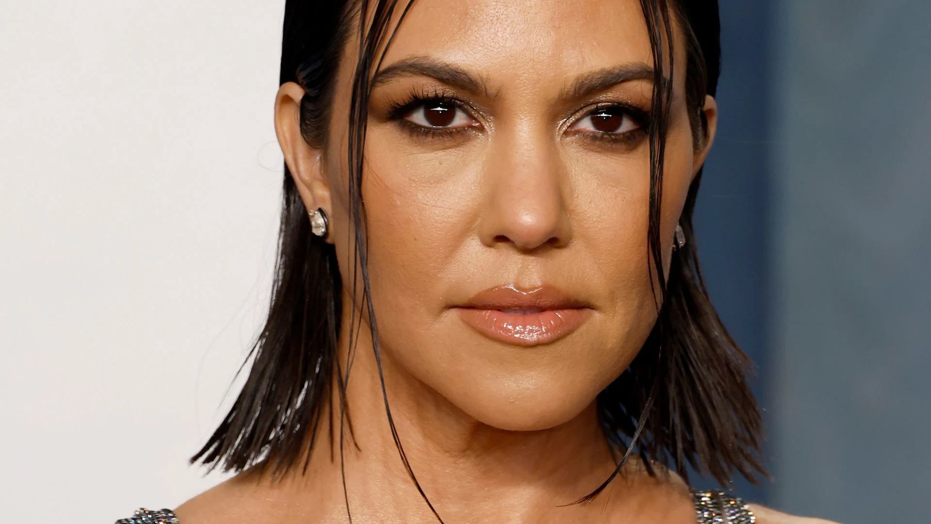 Close-up of Kourtney Kardashian’s face, showing her natural skin and radiant features without any visible Botox.