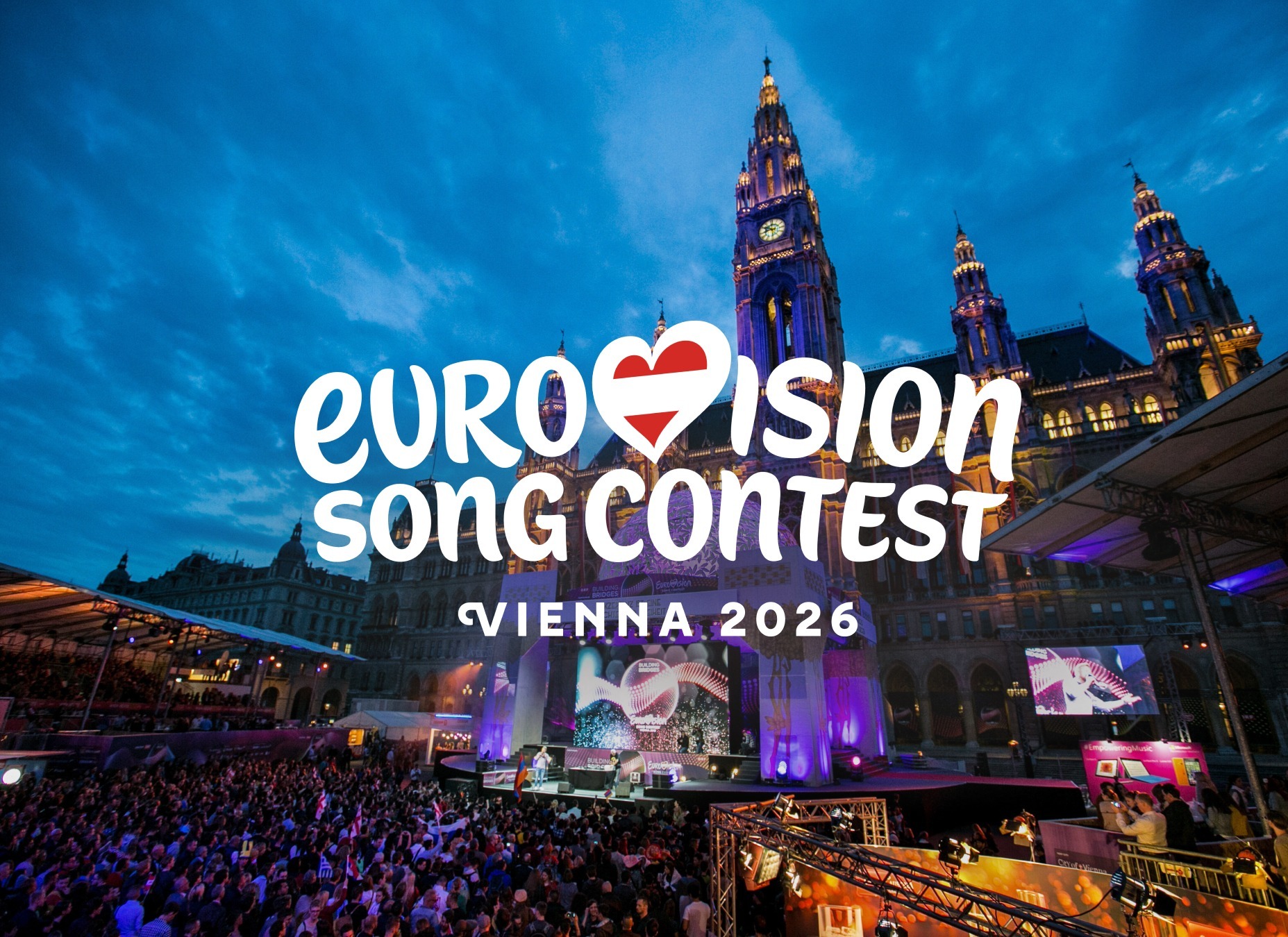 Eurovision Song Contest 2026 logo placed in front of a scenic view of Vienna, with the city’s historic skyline and landmarks illuminated behind it.