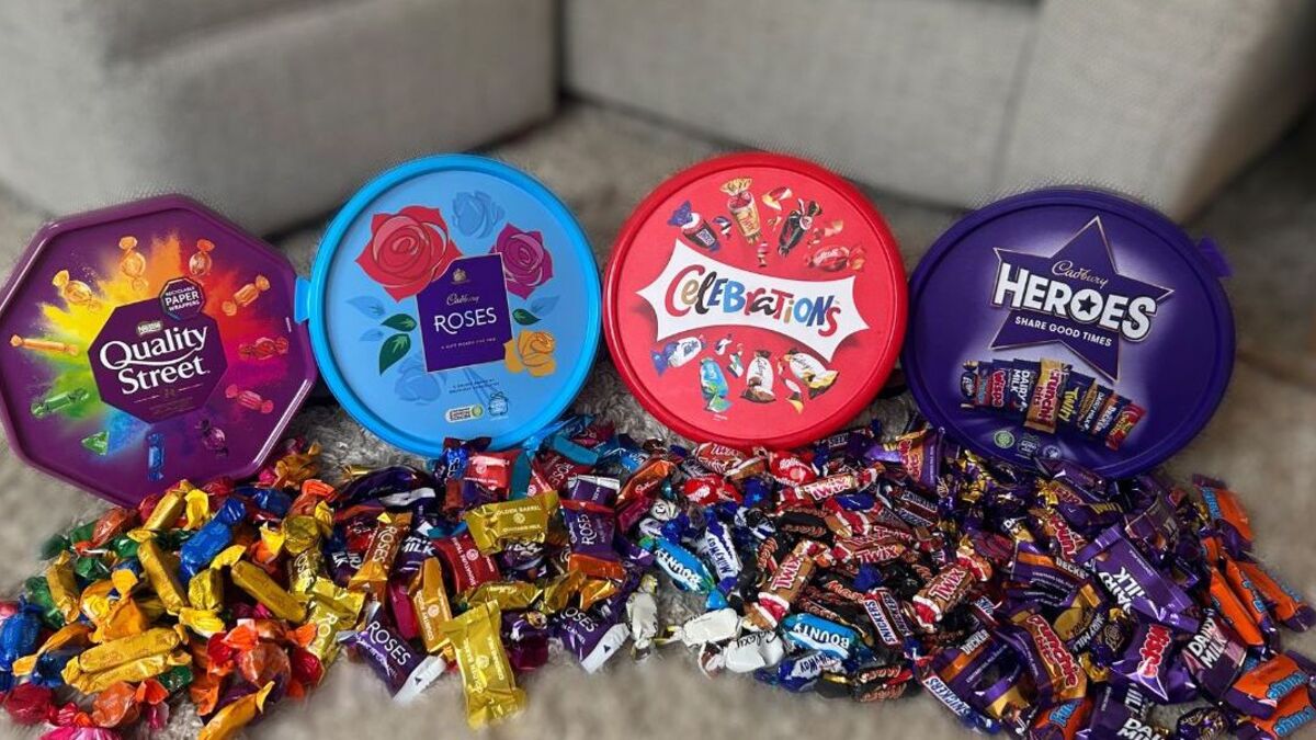 Four popular chocolate tubs — Quality Street, Roses, Celebrations, and Heroes — lined up, clearly showing their reduced sizes compared to previous years.