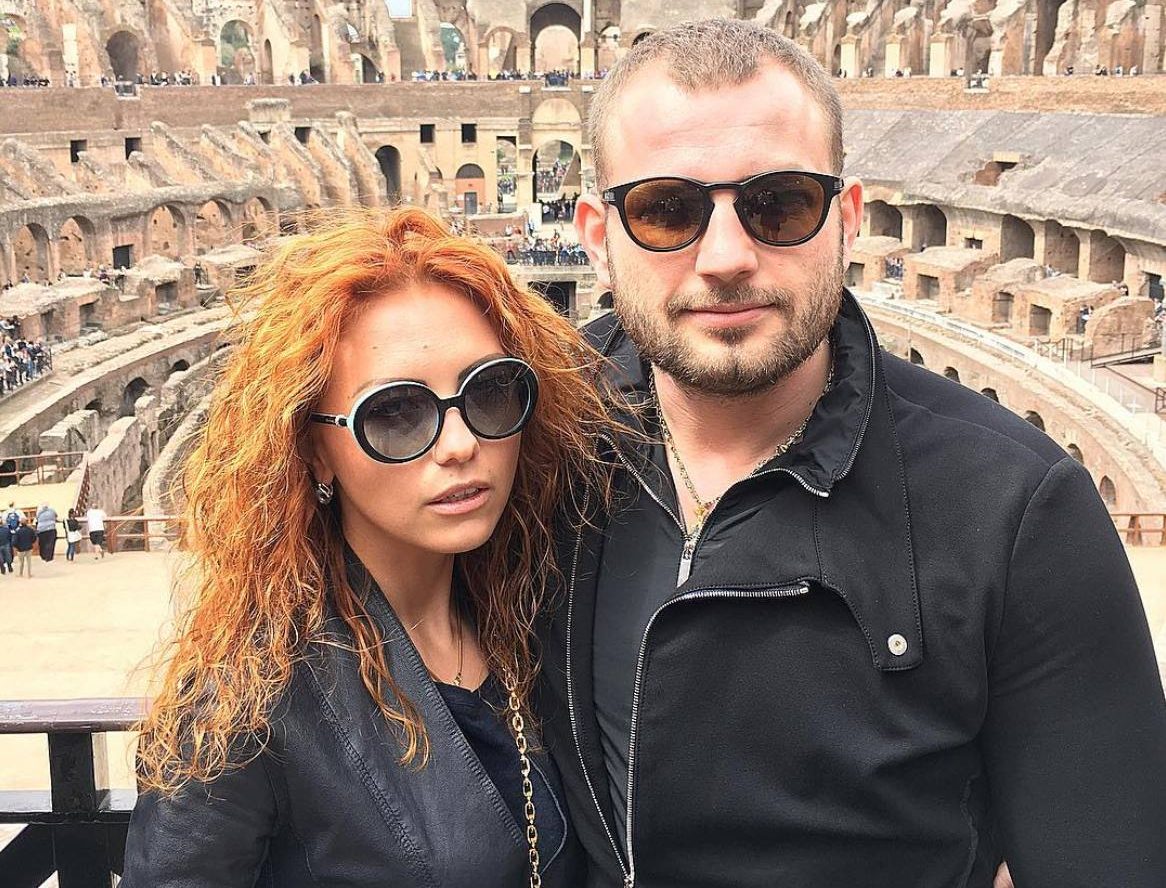 Roman Novak and his wife Anna smiling together during a visit to the Colosseum in Rome, enjoying a rare moment of leisure before their tragic deaths.