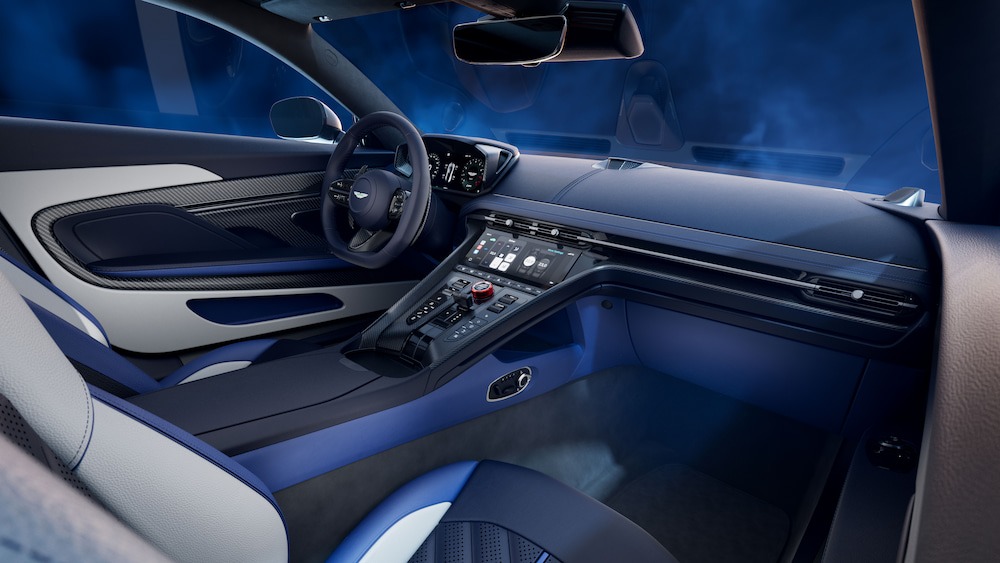 Interior of the Aston Martin DB12 S, showing the leather and Alcantara cockpit, red-anodised drive-mode controller, and sculpted sport seats.