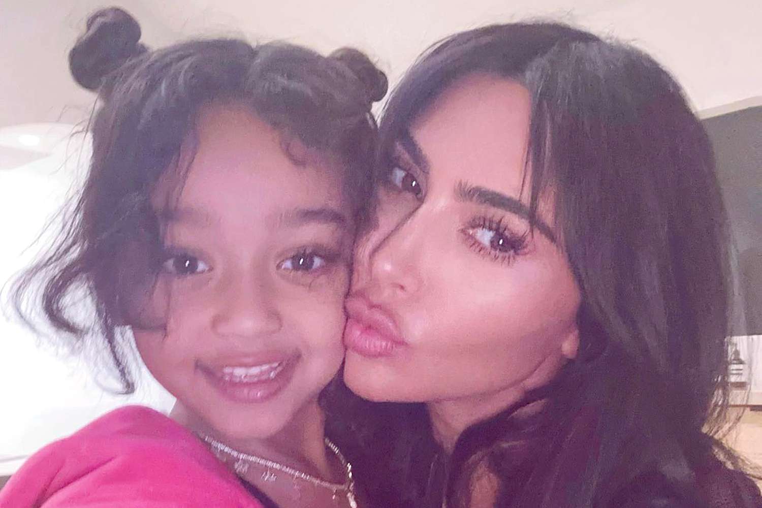 Kim Kardashian posing with her daughter Chicago West, both smiling warmly for a sweet mother-daughter photo.