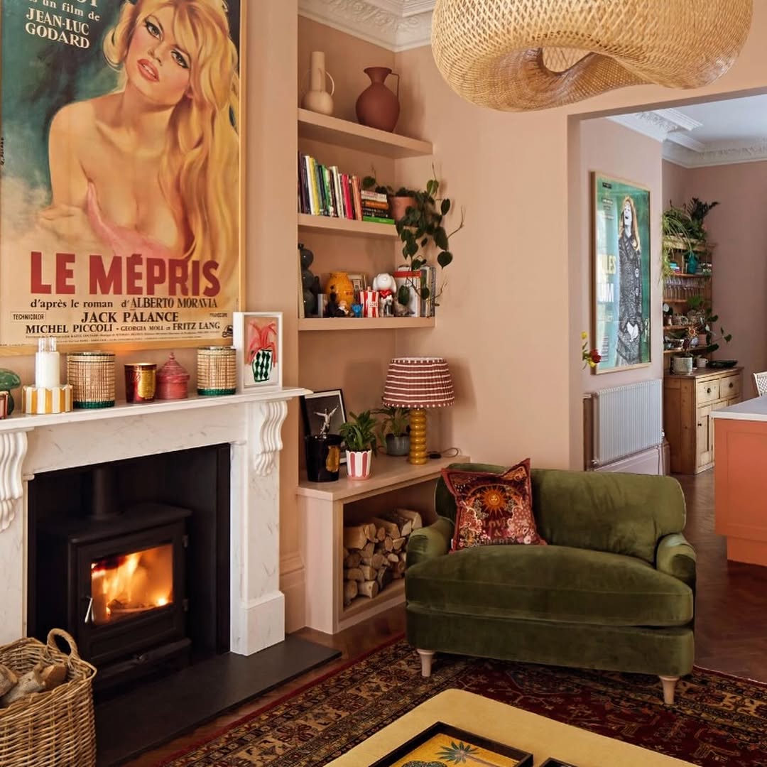 he living room inside Zoe Ball’s Sussex home, featuring warm peach walls, green furnishings, period details and large windows