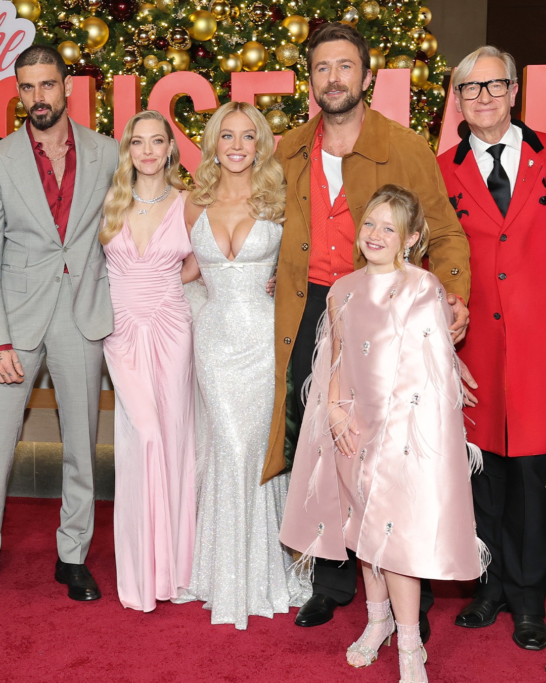 Sydney Sweeney with her fellow cast members on the red carpet at The Housemaid New York premiere, all dressed in glamorous attire.