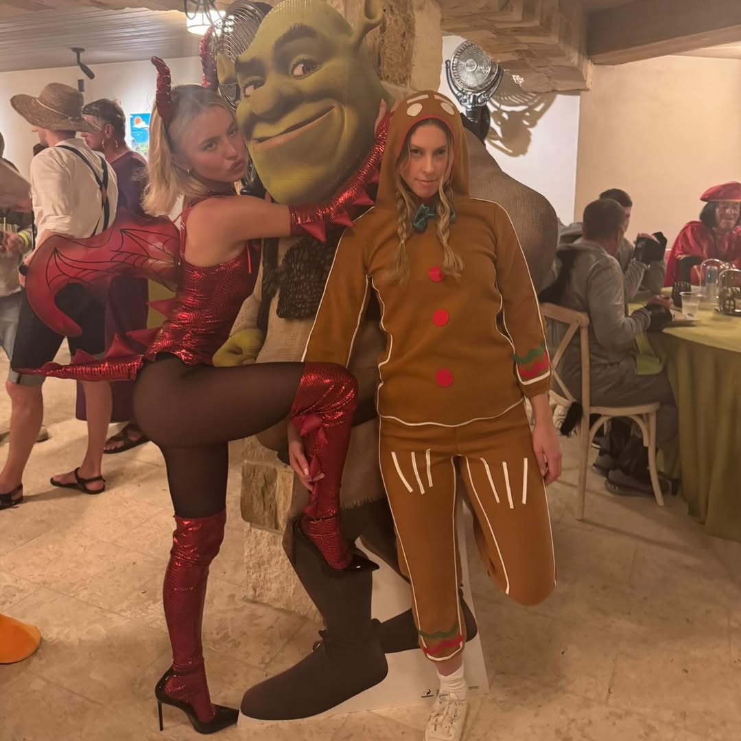 Sydney Sweeney dressed as a metallic dragon hugging a friend dressed as Shrek at her Friendsgiving party.