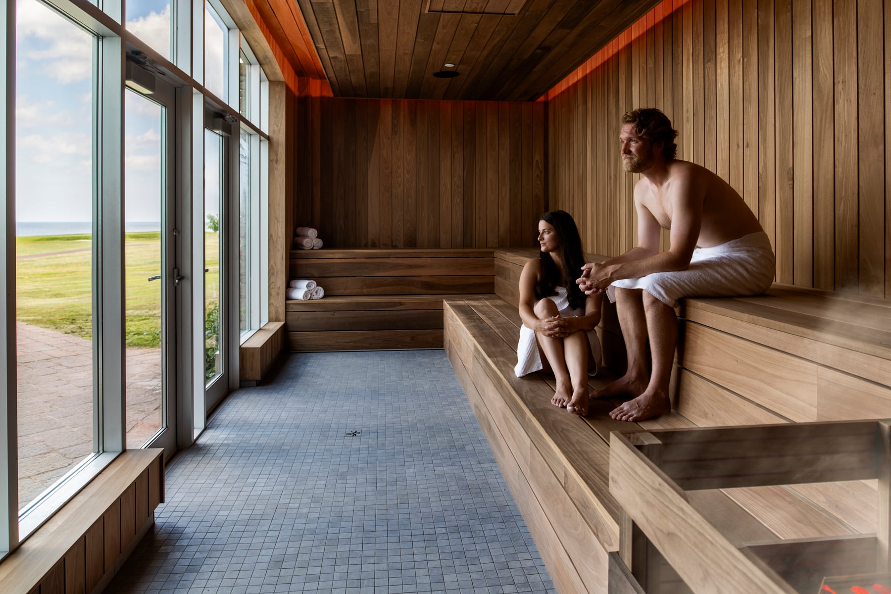 Couple relaxing together in a sauna, enjoying a post-holiday wellness reset and stress relief.